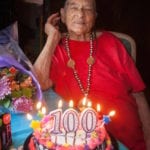 elderly man with 100th birthday cake