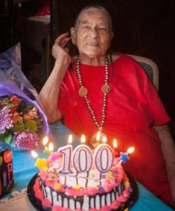 elderly man with 100th birthday cake